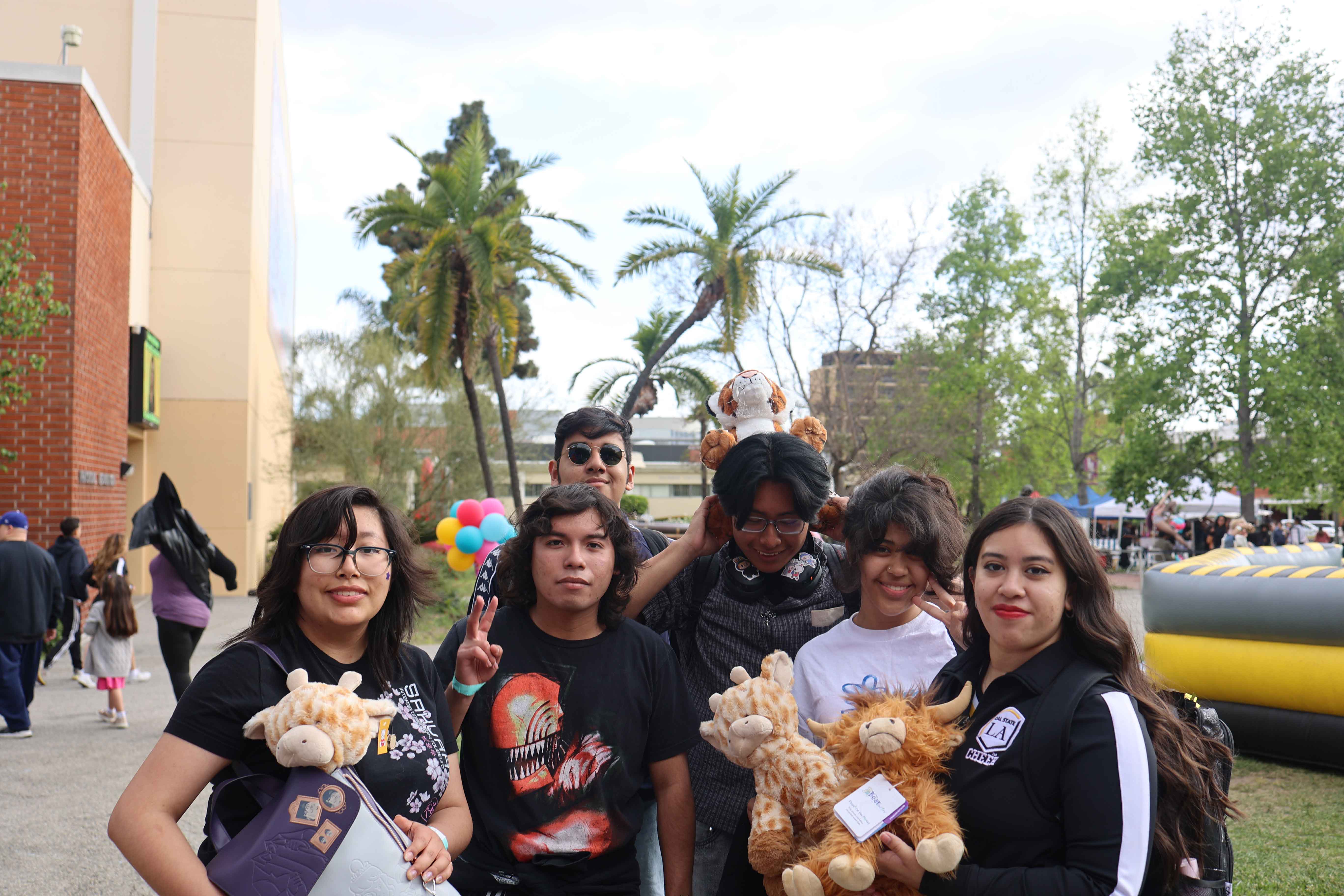 Students posing together with stuffed prizes at Eddie Fest event