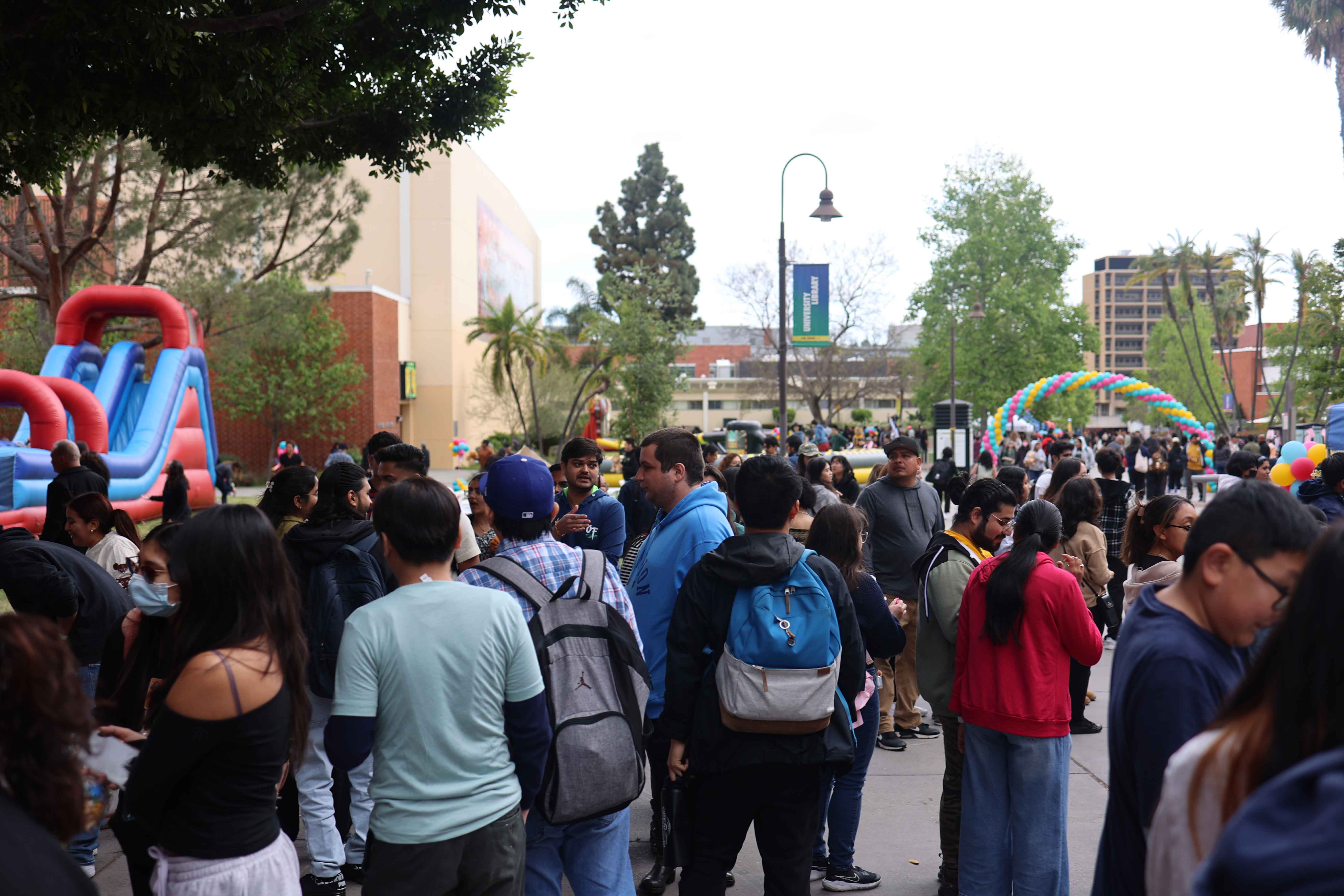 Students climbing a rock wall at Eddie Fest event