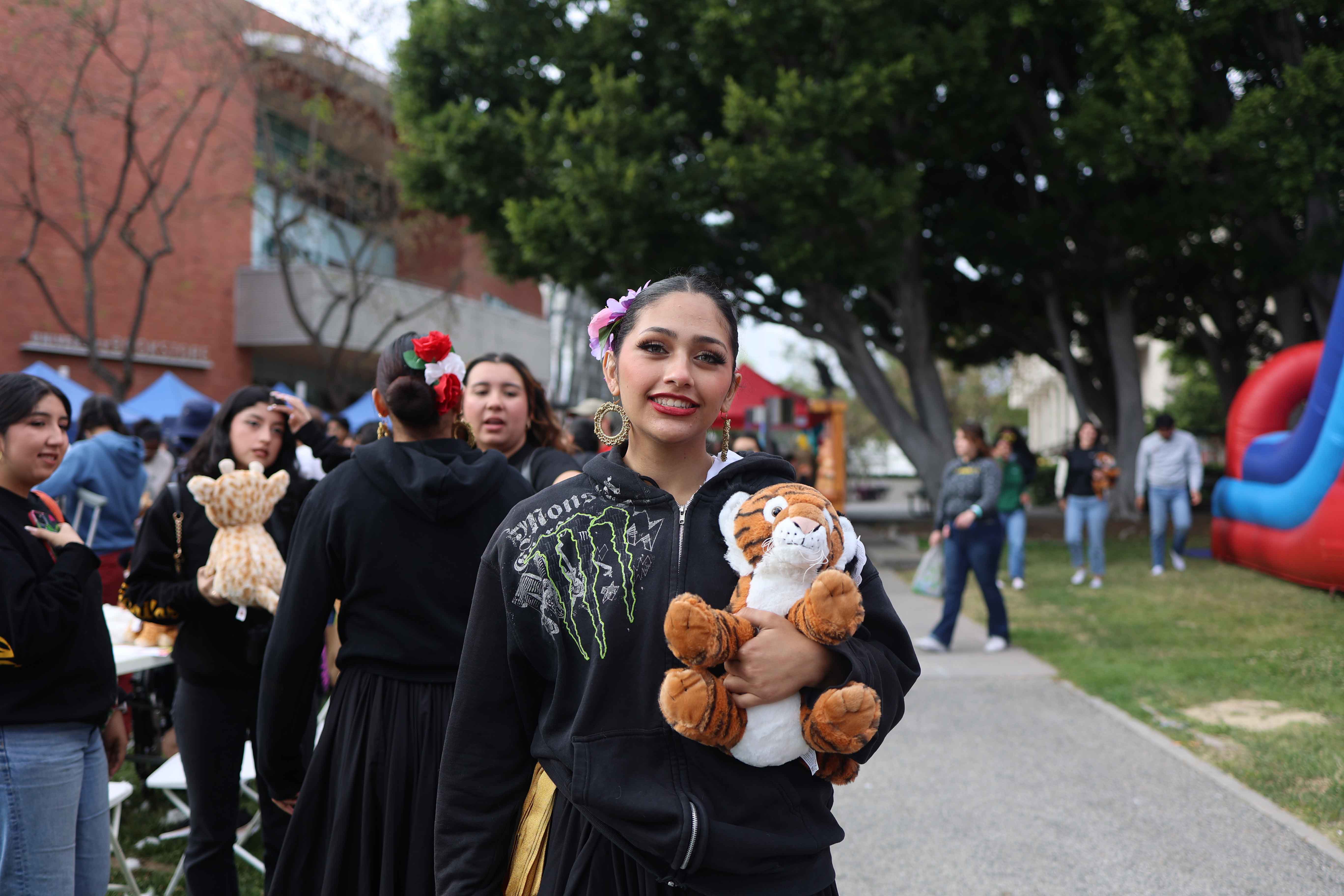Student holding a stuffed animal prize at Eddie Fest