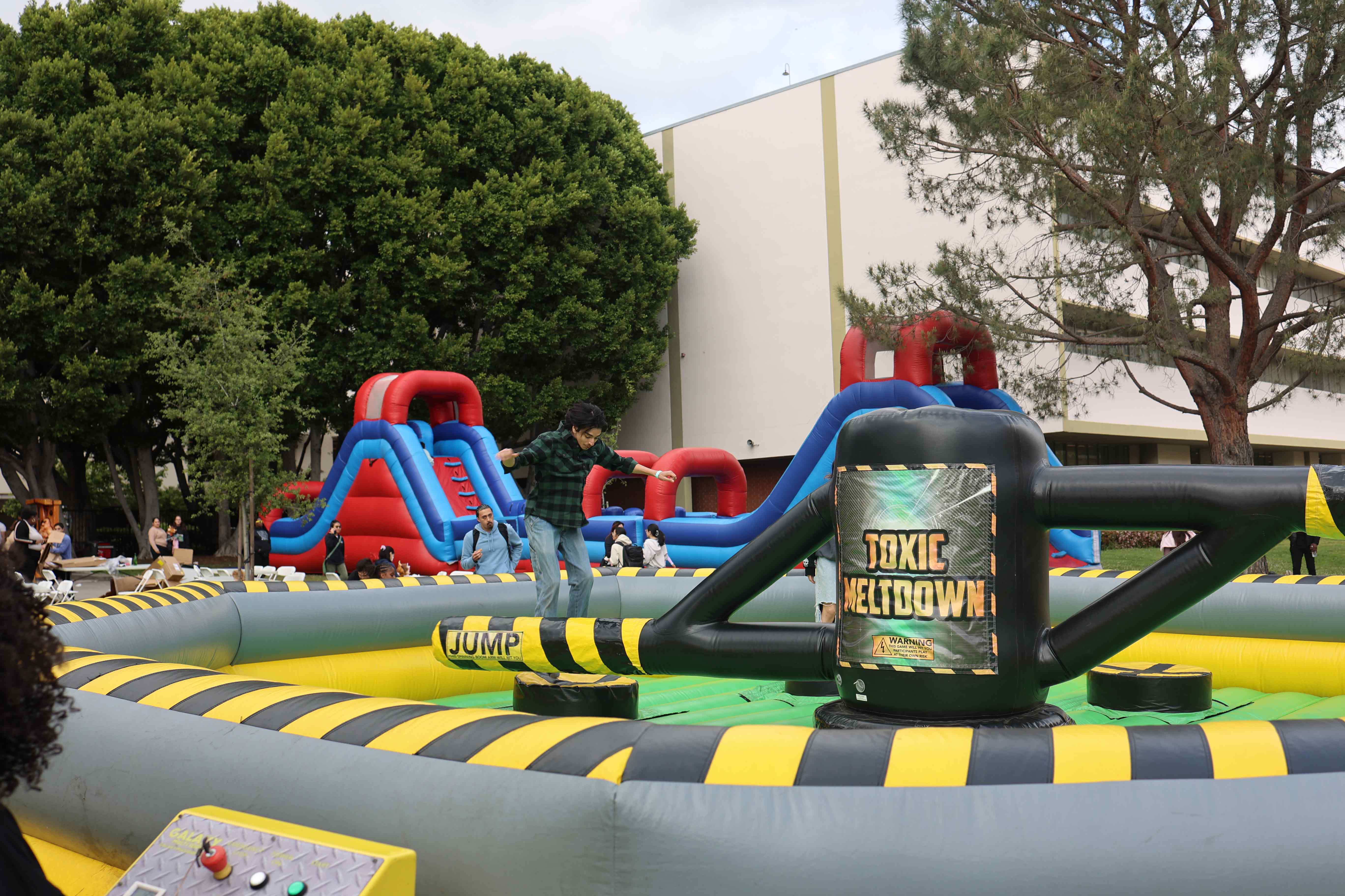 Student balancing on inflatable game obstacle at Eddie Fest