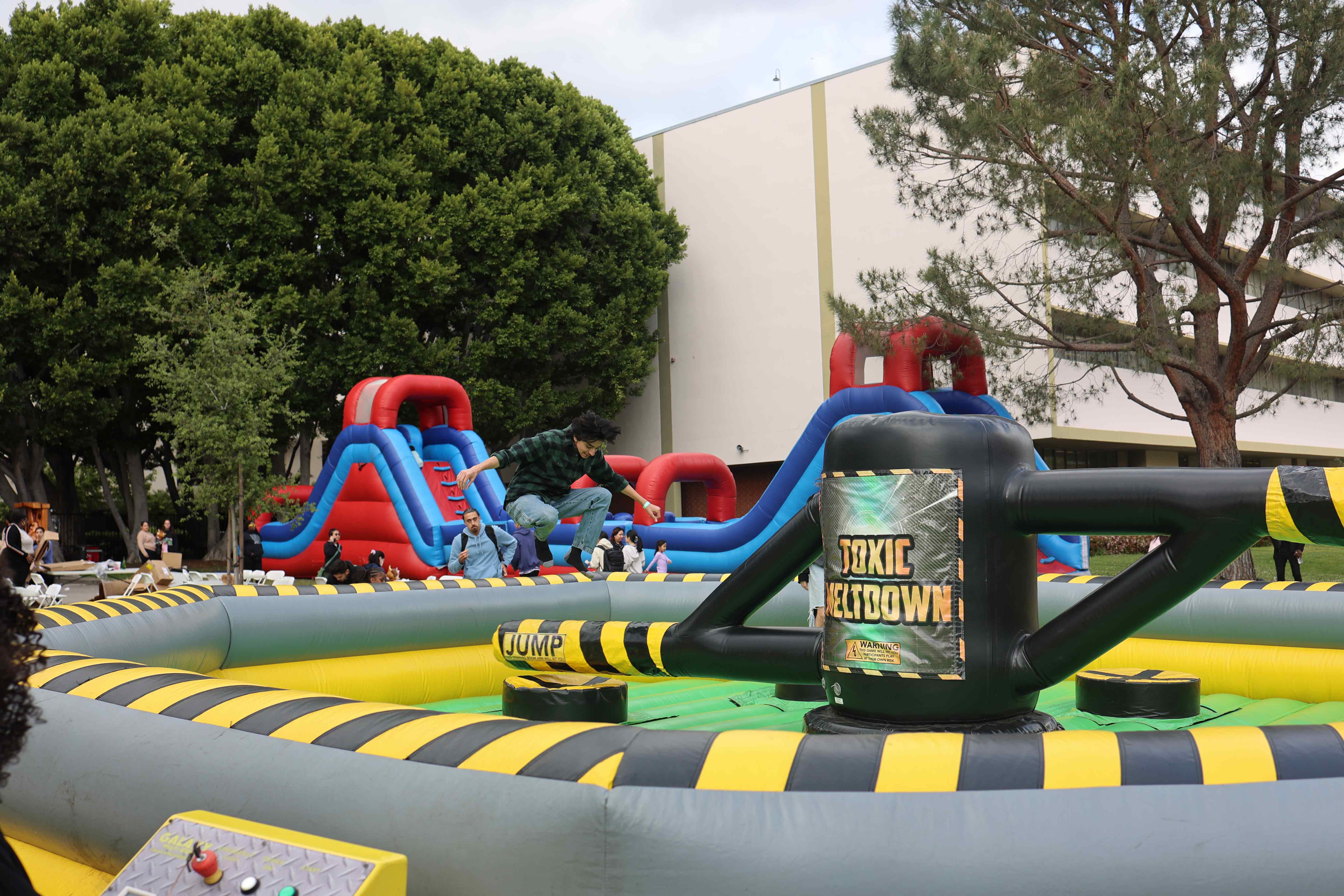 Students playing inflatable obstacle game at Eddie Fest